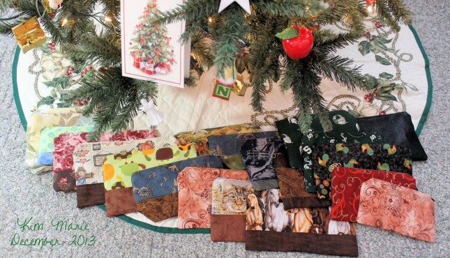 Handmade zippered bags of various fabrics under the Christmas tree.