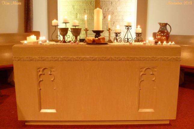 Church sanctuary alter with candles, wine, and bread after worship.
