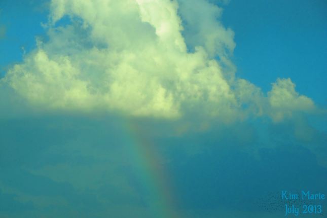 A cloud with the rainbow beneath it.